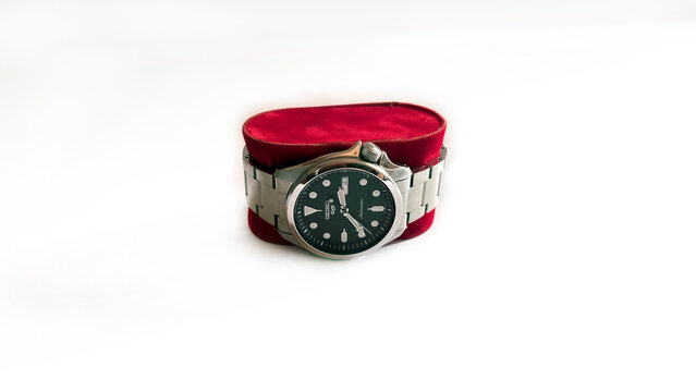 Kediri, East Java, Indonesia &ndash; August 21, 2026: Metallic Wristwatch with Dark Dial Displayed on Red Velvet Case