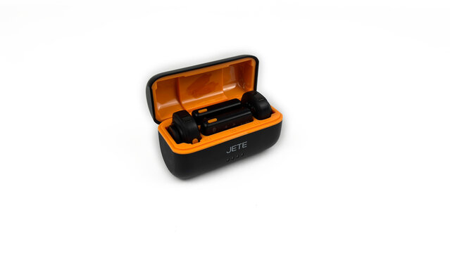 Kediri, East Java, Indonesia &ndash; August 21, 2026: Black and Orange Wireless Microphone Case with Components Displayed on White Background