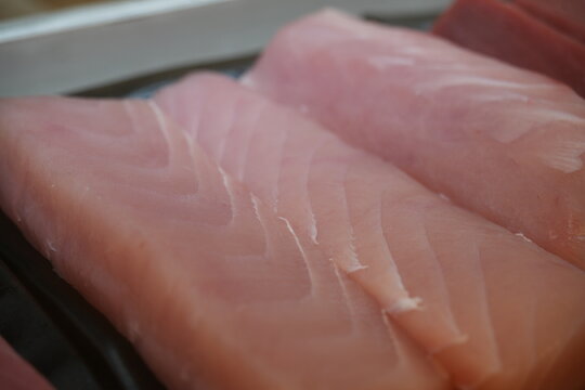 A close up shot of fresh raw swordfish fillets.