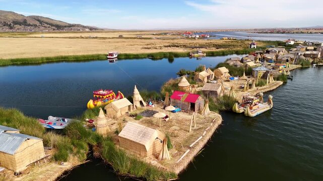 Aerial drone view of the floating Uros Islands on Lake Titicaca. The highest navigable lake in the world, located near Puno, Peru, South America. Popular travel destination.