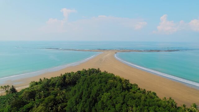 Blue ocean water surrounds unique Whale Tail sandbar of Marino Ballena National Park Costa Rica