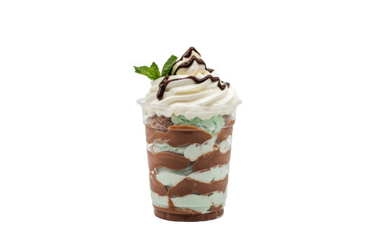 Swirled mint and chocolate ice cream parfait with whipped cream topping isolated on a transparent background