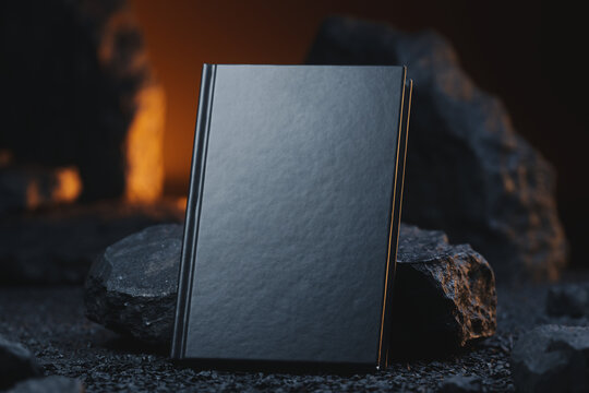Dramatic 3D render of a black hardcover book leaning against a natural stone in warm moody lighting. Macro mockup with copy space for book cover design, catalog, and luxury stationery presentation.