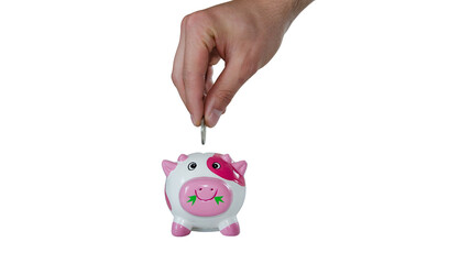Hand dropping a coin into a small white and pink polka dot piggy bank on white background with saving money financial savings ceramic pig coin slot © Sahazadi