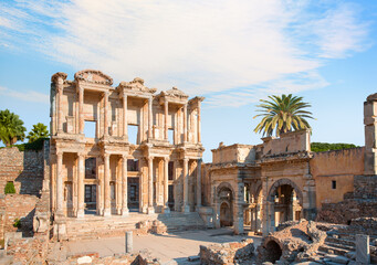 Celsus Library in Ephesus palm tree in the background - Selçuk, Turkey © muratart