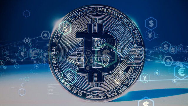 Bitcoin cryptocurrency and decentralized finance concept. Silver digital bitcoin physical coin overlaying glowing virtual currency icons and network connections on a blue background.
