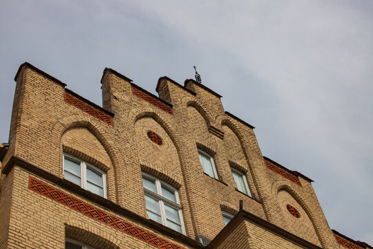 Historic Neo-Gothic Brick Facade with Stepped Gable and Arched Windows