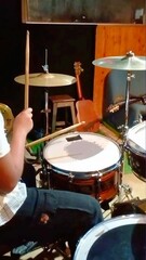Obraz premium ​Musician Hands Playing Drum Kit in Music Studio Vertical Shot