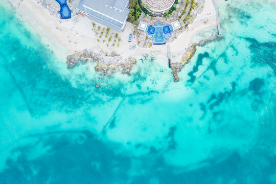 Aerial view of sandy beach and ocean with small waves in Cancun, Mexico. Top view from drone. Playa Caracol of Riviera Maya in Quintana roo region on the Yucatan Peninsula