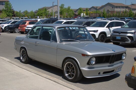 Silver classic BMW 2002 coupe parked in a lot