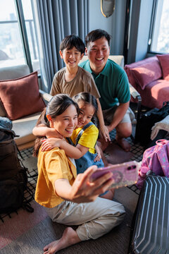 A happy family taking a selfie on vacation.