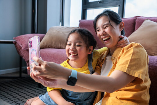 Happy mother and daughter taking a selfie together.