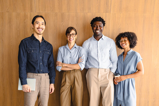 Group of Four People Standing Together in an Indoor Space