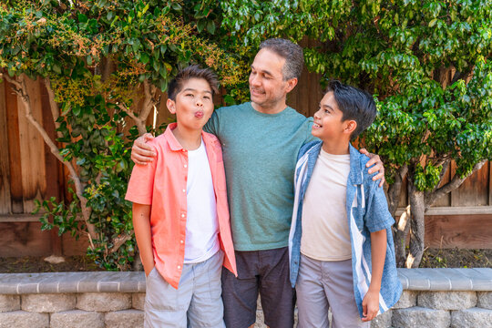 father and two sons funny playful portrait 