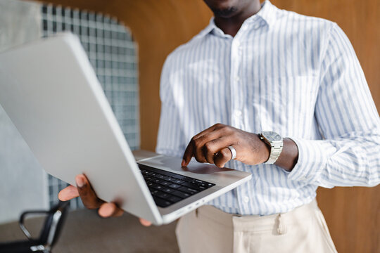 Man Working on Laptop in Office During Daytime