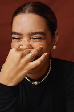 Woman covering mouth laughing having genuine joy