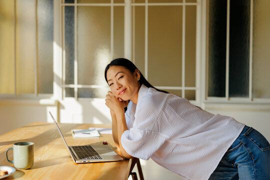 Woman smiling while relaxing during a break at home