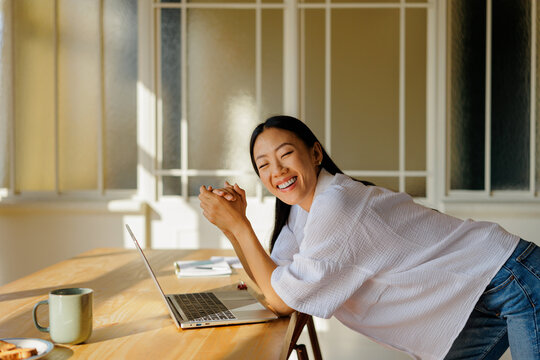 Happy woman laughing while taking a work break