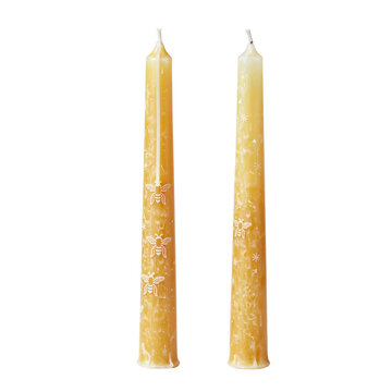 Pair of beeswax taper candles with textured natural wax, isolated on transparent background
