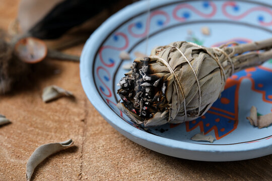 White Sage Smudge Stick on Blue Decorative Plate with Feather