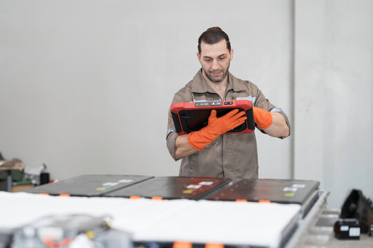 EV car repair, maintenance, inspecting services. Mechanic diagnosing battery pack, component checks, electric car vehicles battery, electric car software update, testing and install at auto workshop