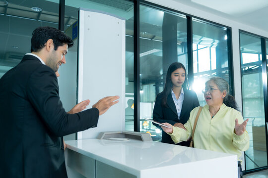 Airport staff engage with a dissatisfied traveler during a difficult conversation emphasizing professional communication service recovery and passenger support.