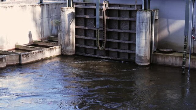 Closed water lock gate with swirling river water on Elbe River in Velky Osek, Czech Republic.
