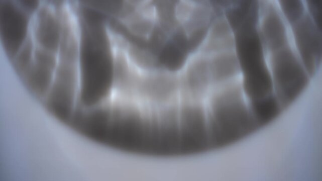 Soft caustic reflections create a blurred defocused abstract background with gentle light and shadow. Concept versatile backdrop for ads, websites, banners and presentations.