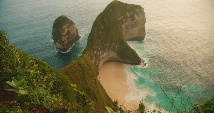 Iconic rock formation and hidden cove at Kelingking beach in Nusa Penida Bali