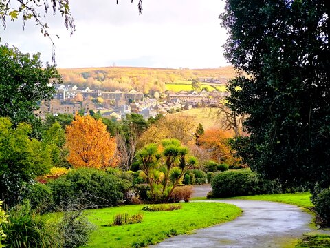 Winding footpath in a public park with vibrant autumn foliage, overlooking Haworth Valley, the famous Bront&euml; Country landscape that inspired Emily Bront&euml;＇s novel Wuthering Heights. 