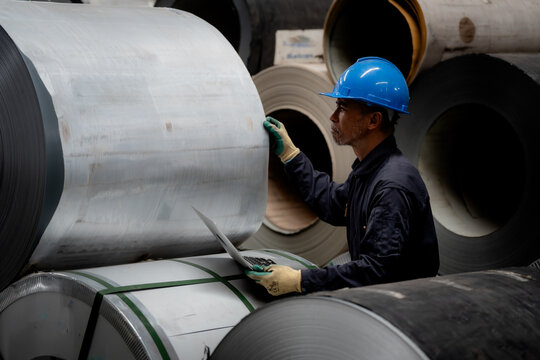 Worker engineer, Industrial Engineers in Hard Hats. Work at the Heavy Industry Manufacturing Factory. industrial worker indoors in factory. man working in an industrial factory. Safety first concept.