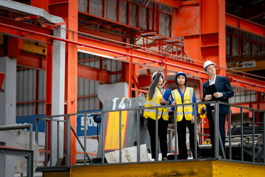Industrial leadership and factory inspection. Engineers and managers review production operations on a manufacturing platform. Leadership, inspection, industry, teamwork, manufacturing