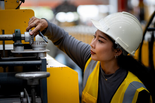 Happy women engineer worker enjoy working in factory industry.