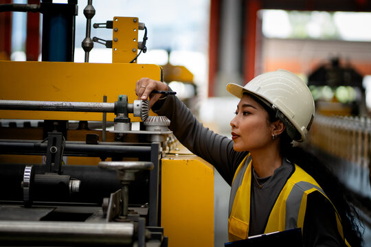 Happy women engineer worker enjoy working in factory industry.