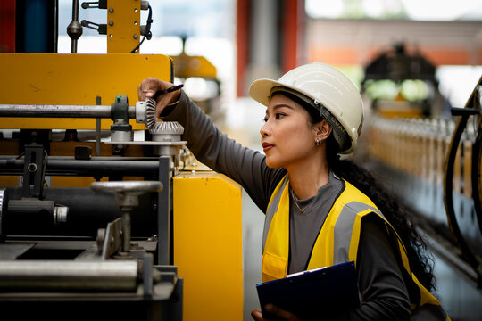 Happy women engineer worker enjoy working in factory industry.
