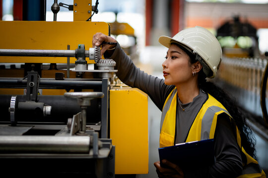 Happy women engineer worker enjoy working in factory industry.