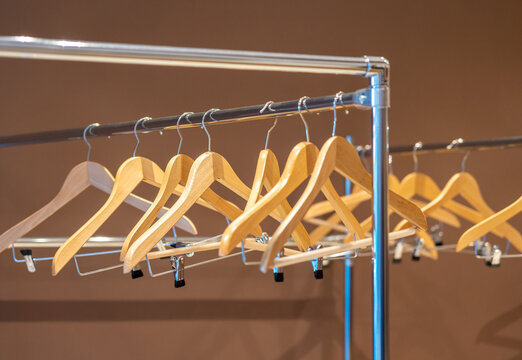 Wooden hangers on coat rack with no clothes in wardrobe