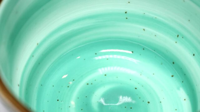 A close-up view of a green bowl, perfect for food or nature photography. Rotating in a circle