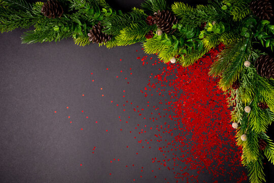 Christmas tree branches on the black background. flat lay, top view with copy space