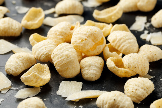 Hummus Chips with Italian Cheese and Black Pepper on dark background