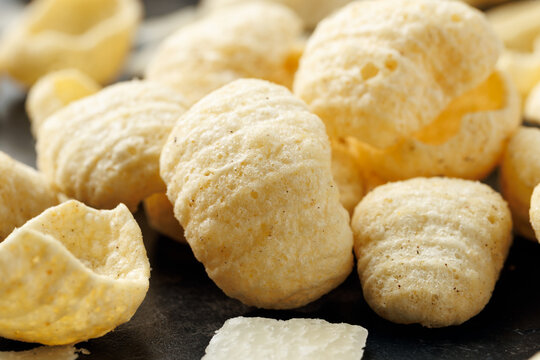 Hummus Chips with Italian Cheese and Black Pepper on dark background