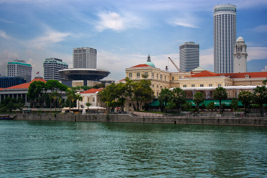 SINGAPORE - August 21, 2011: Scenic view of the Singapore River with the Asian Civilisations Museum, Victoria Theatre Clock Tower, Swissotel The Stamford, and the Supreme Court building.