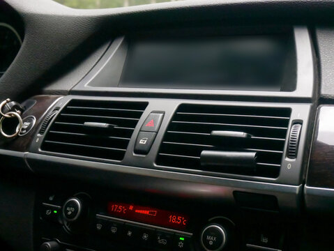 Car dashboard with digital climate control and air vents
