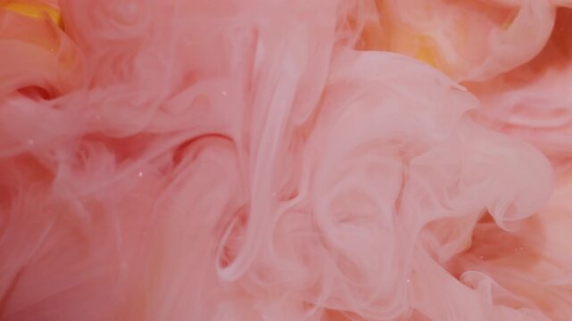 Haze ink. Explosion mist. Blur orange yellow pink colorful fog splash spill texture glitter cloud spreading on abstract background.