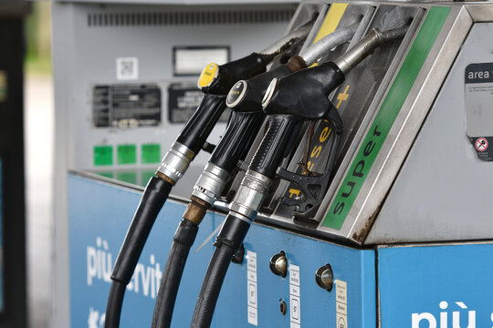 Fuel pump nozzles at a service station. Close up of multiple fuel pump nozzles at a service station. Gasoline and diesel refueling equipment. Fueling service.