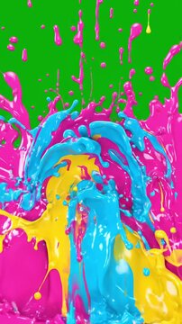 Colorful paint splashes and liquid drops on bright green background
