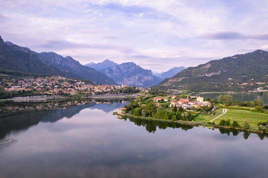 View into land across Lake Annone at dawn of Civate and Annone di Brianza, Lecco Province, Lombardy, Italy