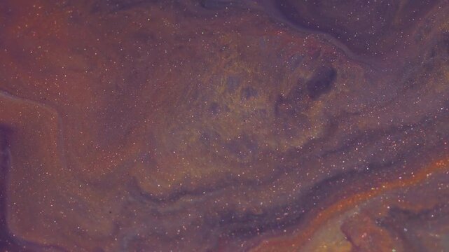 Paint spatter. Color glitter mix. Defocused orange yellow blue bright water ripple marble flow spill on abstract acrylic art background.