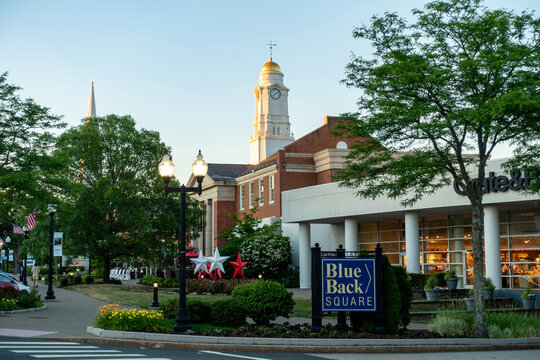 Corner in Blue Back Square (plus signage for the neighborhood) in downtown West Hartford, Connecticut (CT) at dusk. Includes a furniture store, a cafe, sidewalk and street.