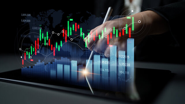 A professional hand analyzes financial data on a tablet, showcasing stock market graphics and trends. Perfect for illustrating modern trading and investment strategies. Scalp
